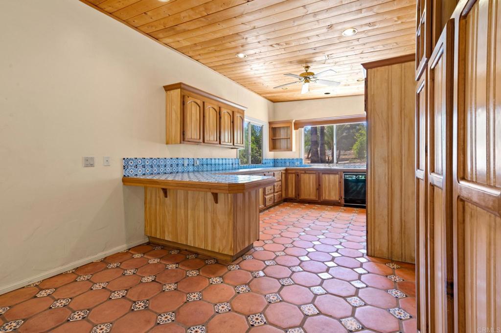 13511 Hilldale Road Valley Center, CA 92082 - Photo 37 of 46 a spacious bathroom with a granite countertop sink and a mirror