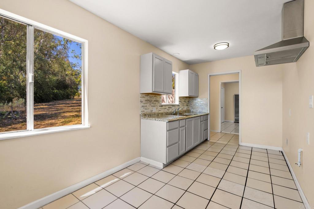 13511 Hilldale Road Valley Center, CA 92082 - Photo 46 of 46 a kitchen with a refrigerator a sink and cabinets