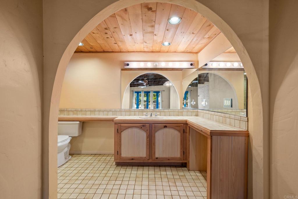 13511 Hilldale Road Valley Center, CA 92082 - Photo 6 of 46 a bathroom with a sink mirror and vanity