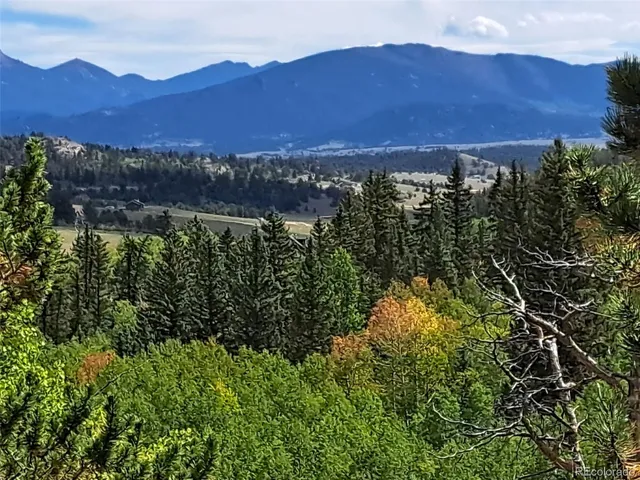 an aerial view of residential house with outdoor space and mountain view