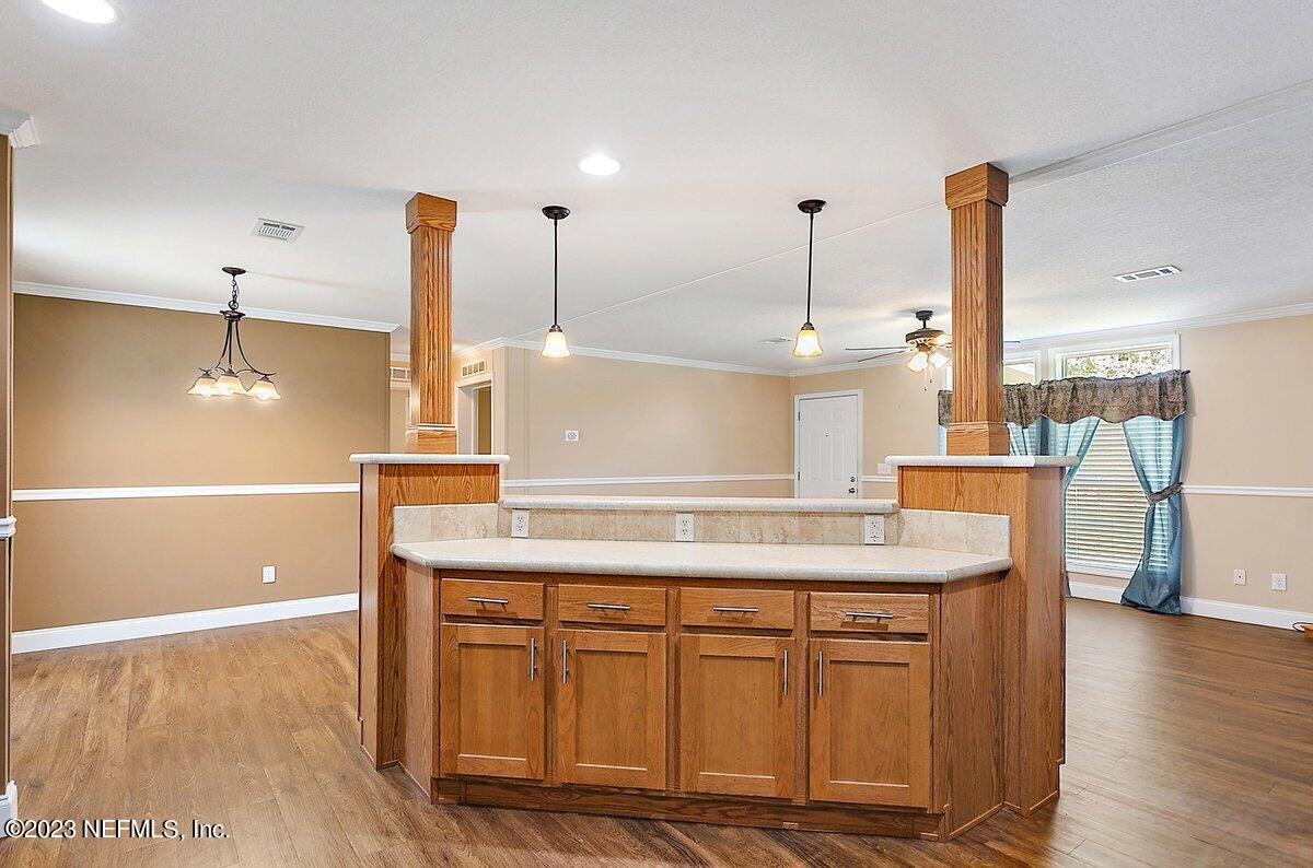 3823 Rancho Road Jacksonville, FL 32221 - Photo 8 of 17 a kitchen with kitchen island a sink appliances and wooden floor