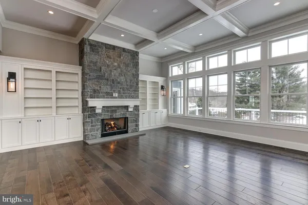a view of an empty room with a fireplace and a window