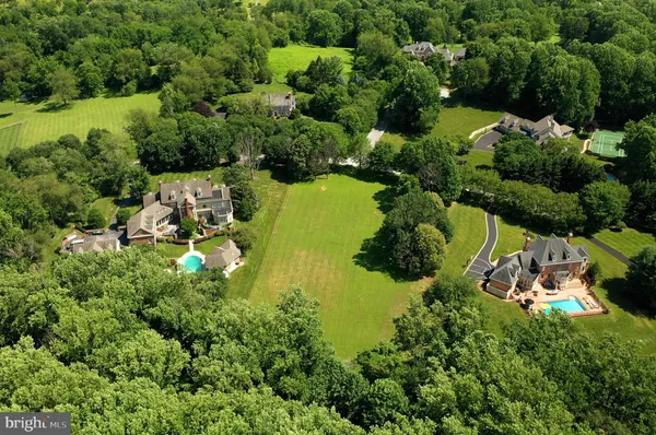 an aerial view of a houses with a yard