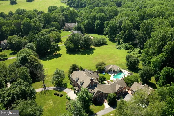 an aerial view of a house with yard