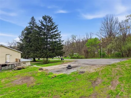 a kitchen with stainless steel appliances granite countertop a sink a stove a refrigerator cabinets and living room view