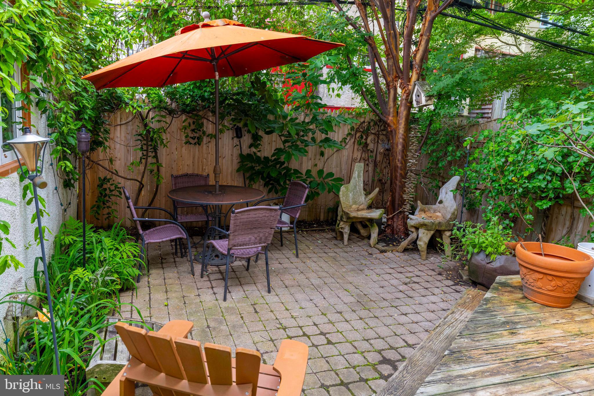 315 Wellesley Road Philadelphia, PA 19119 - Photo 14 of 32 a view of a patio with chairs and table under an umbrella