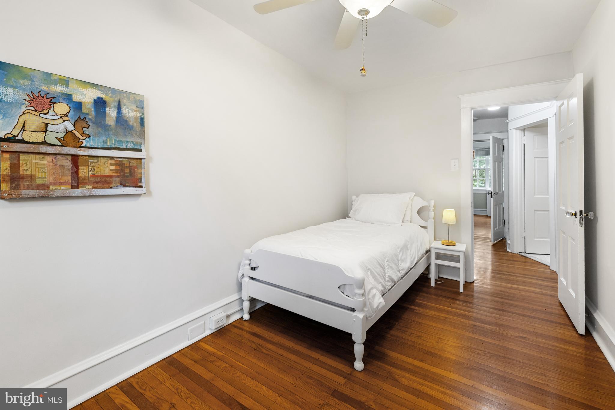 315 Wellesley Road Philadelphia, PA 19119 - Photo 23 of 32 a bedroom with a bed and wooden floor