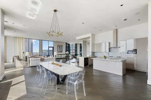 a large kitchen with a table and chairs
