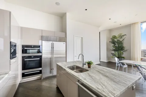 a kitchen with stainless steel appliances kitchen island granite countertop a sink and cabinets