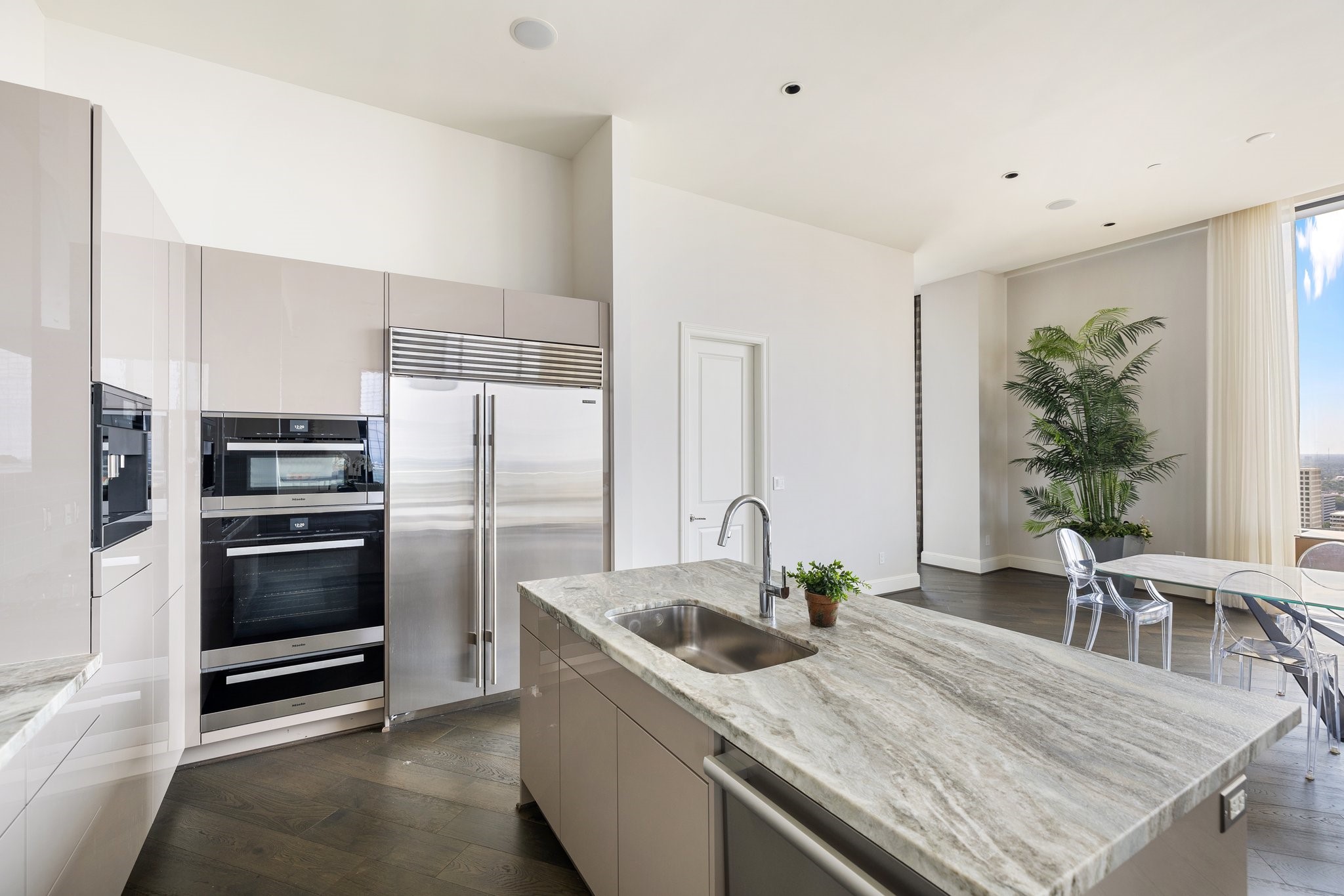 1409 Post Oak Boulevard, Unit 2702 Houston, TX 77056 - Photo 13 of 43 a kitchen with granite countertop a sink and stainless steel appliances