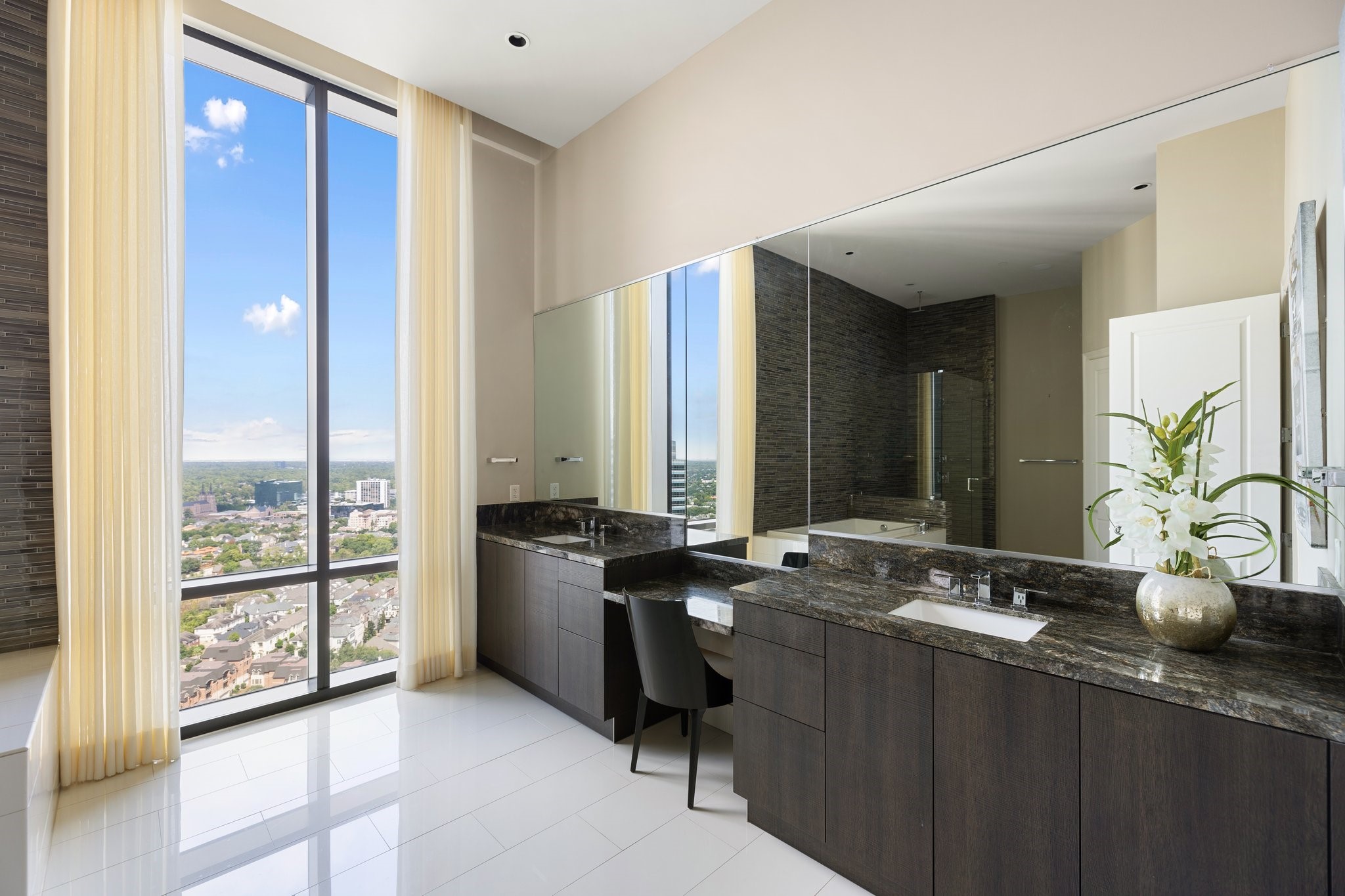 1409 Post Oak Boulevard, Unit 2702 Houston, TX 77056 - Photo 17 of 43 a bathroom with double vanity and a bathtub
