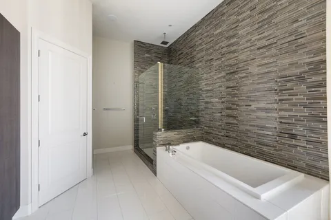 a bathroom with double vanity and a bathtub