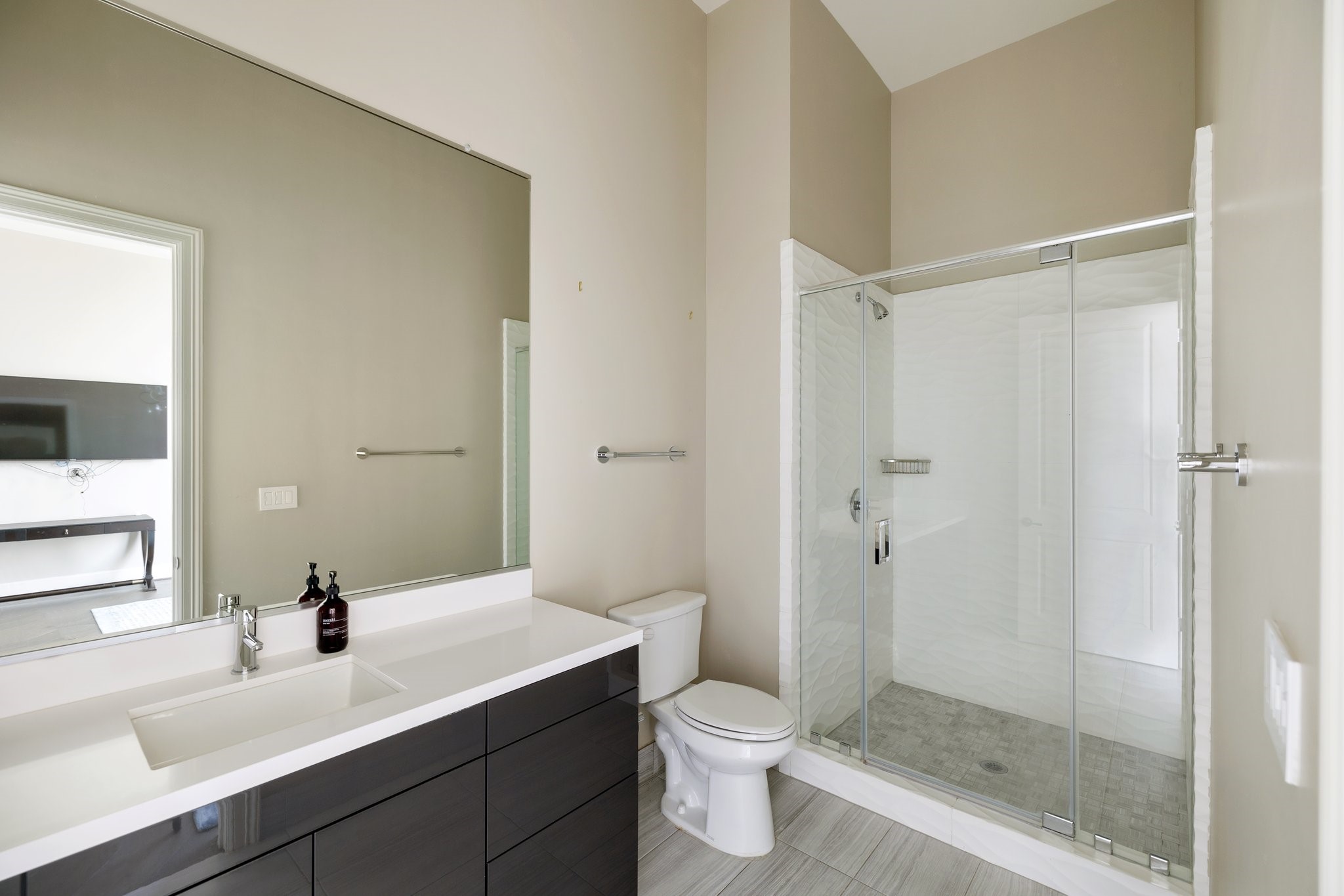 1409 Post Oak Boulevard, Unit 2702 Houston, TX 77056 - Photo 22 of 43 a bathroom with a sink a toilet and shower