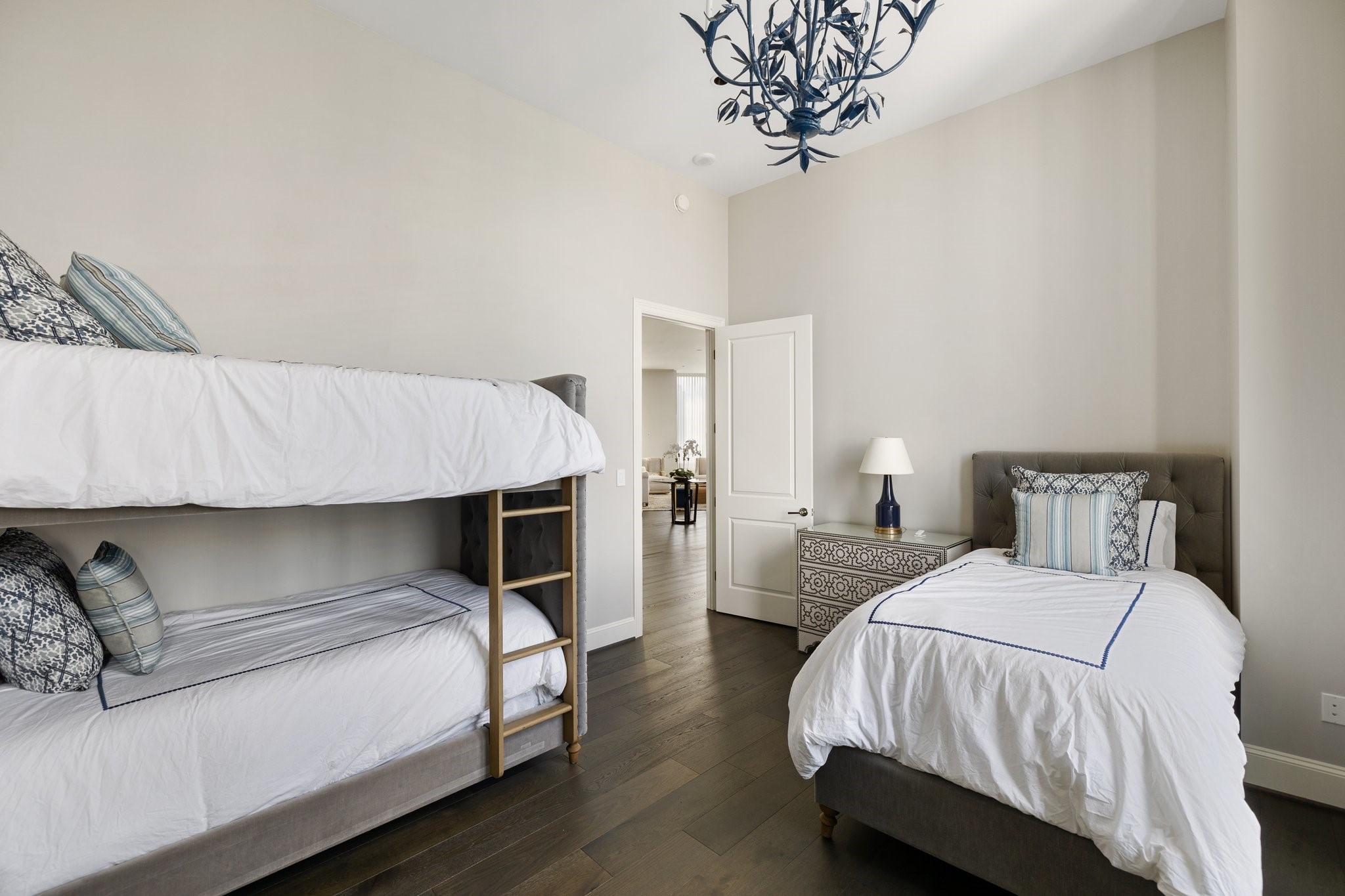 1409 Post Oak Boulevard, Unit 2702 Houston, TX 77056 - Photo 25 of 43 a bedroom with a bed and a chandelier