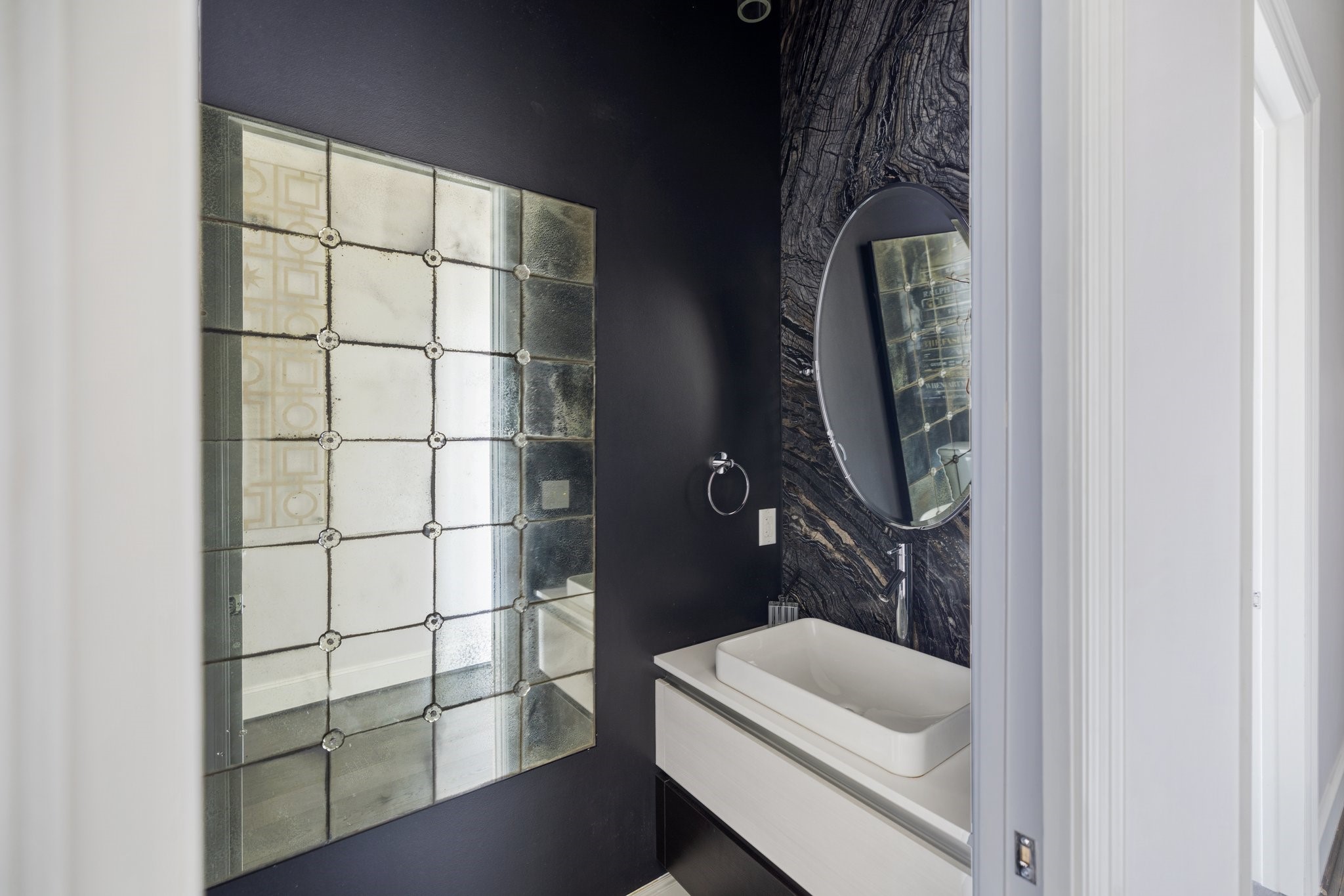 1409 Post Oak Boulevard, Unit 2702 Houston, TX 77056 - Photo 29 of 43 a bathroom with a sink and a mirror