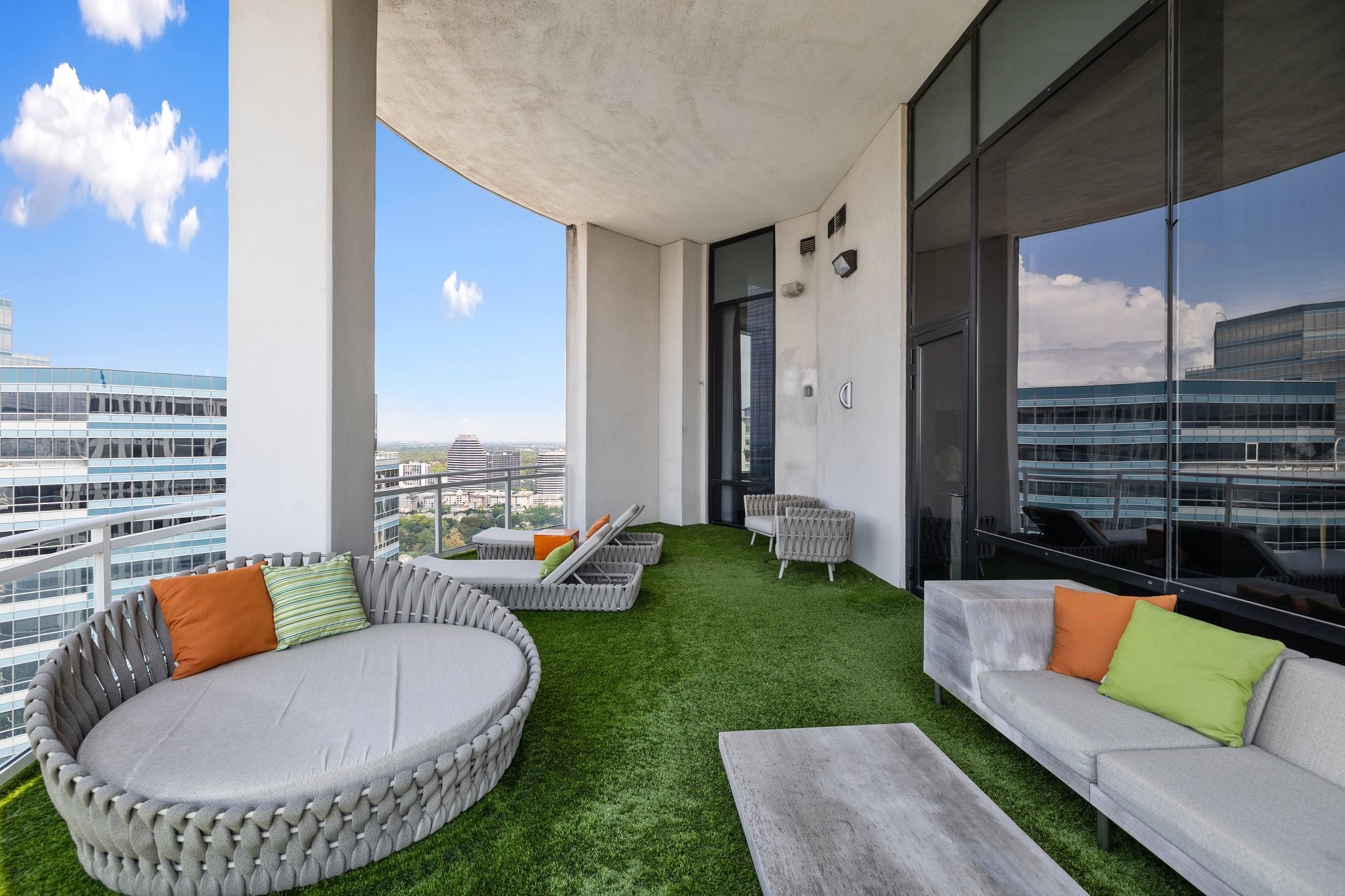 1409 Post Oak Boulevard, Unit 2702 Houston, TX 77056 - Photo 31 of 43 a view of a patio with couches chairs and a fire pit