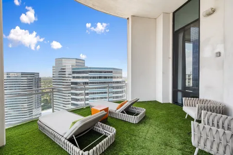 a view of a patio with couches chairs and a fire pit