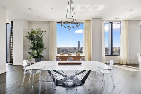 a living room with furniture and large windows