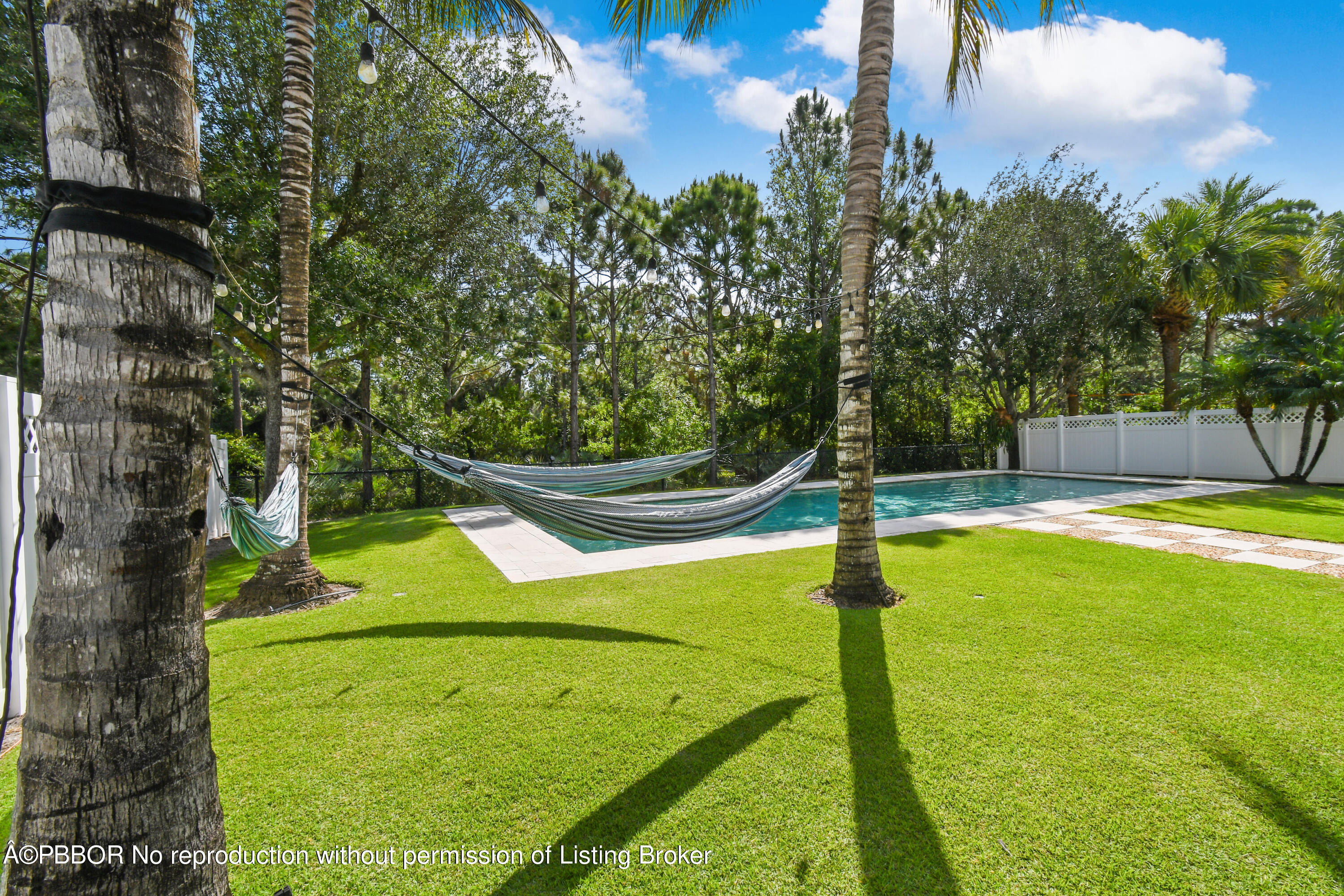 139 Florence Drive Jupiter, FL 33458 - Photo 27 of 33 a view of a swimming pool with a yard and large tree