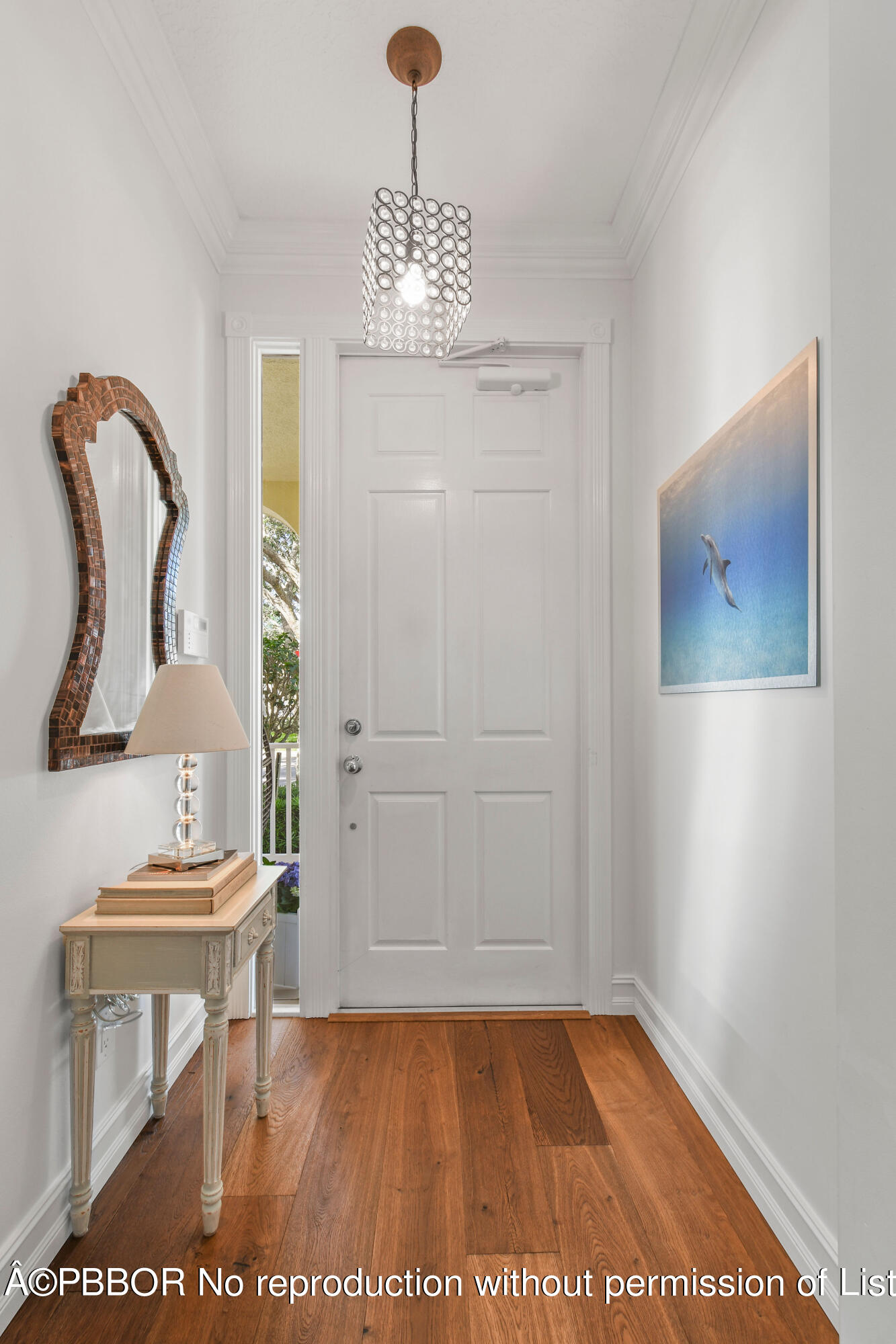 139 Florence Drive Jupiter, FL 33458 - Photo 4 of 33 a view of a hallway with wooden floor and furniture