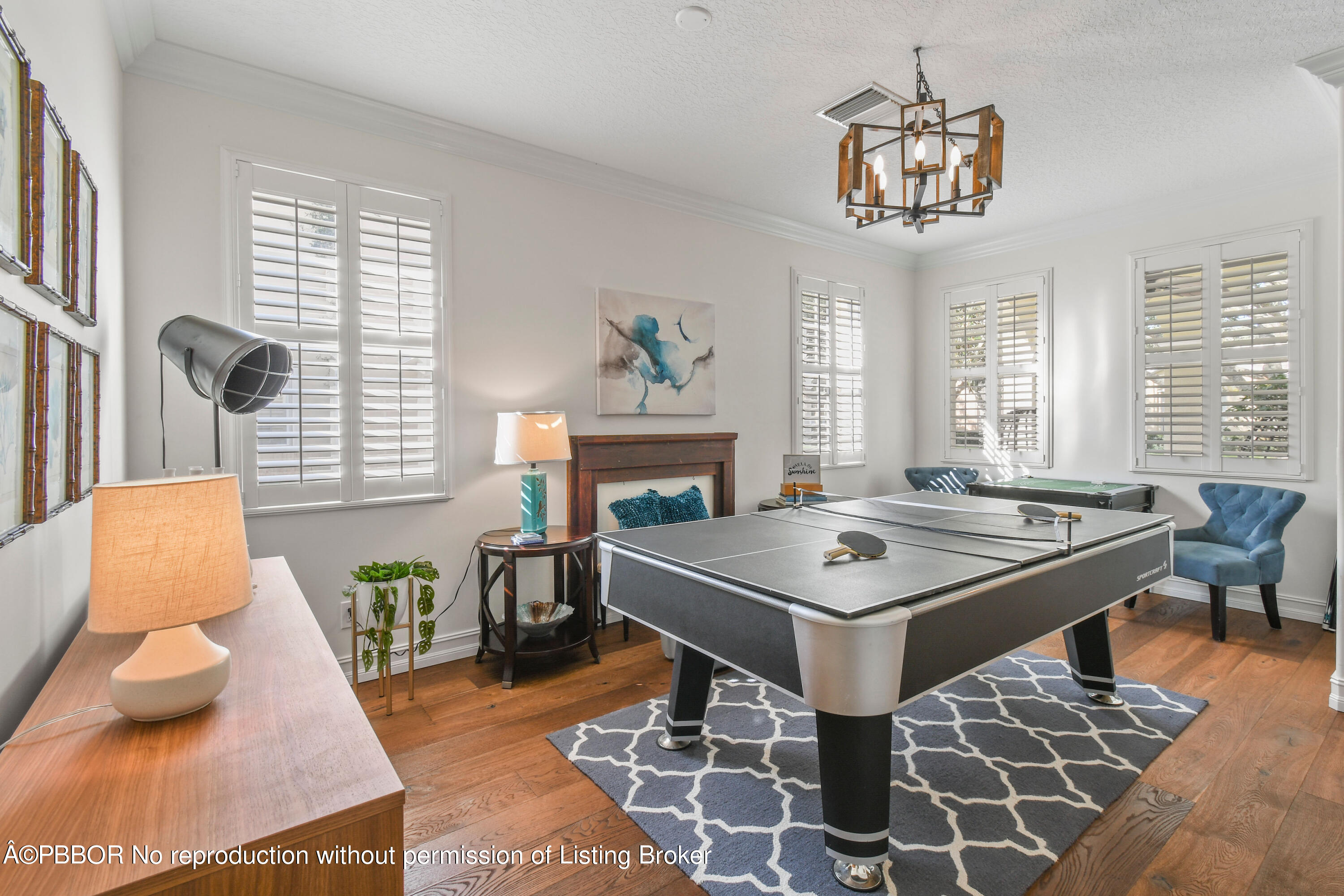 139 Florence Drive Jupiter, FL 33458 - Photo 6 of 33 a dining room with wooden floor a chandelier a wooden table and chairs