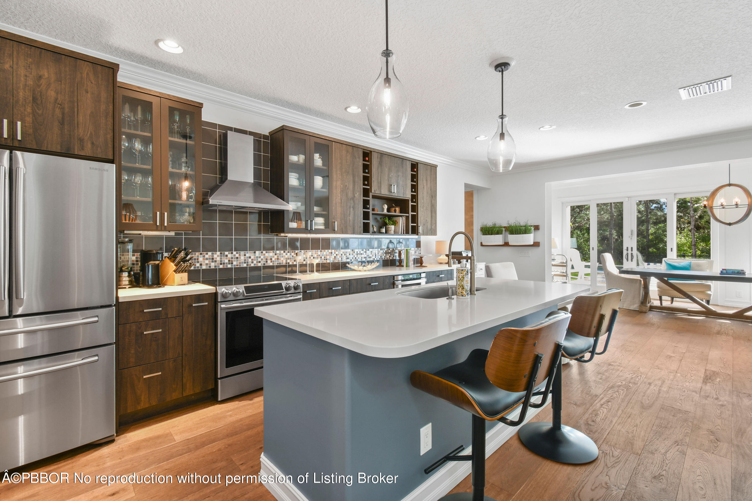 139 Florence Drive Jupiter, FL 33458 - Photo 9 of 33 a kitchen with stainless steel appliances granite countertop a sink a stove and a refrigerator