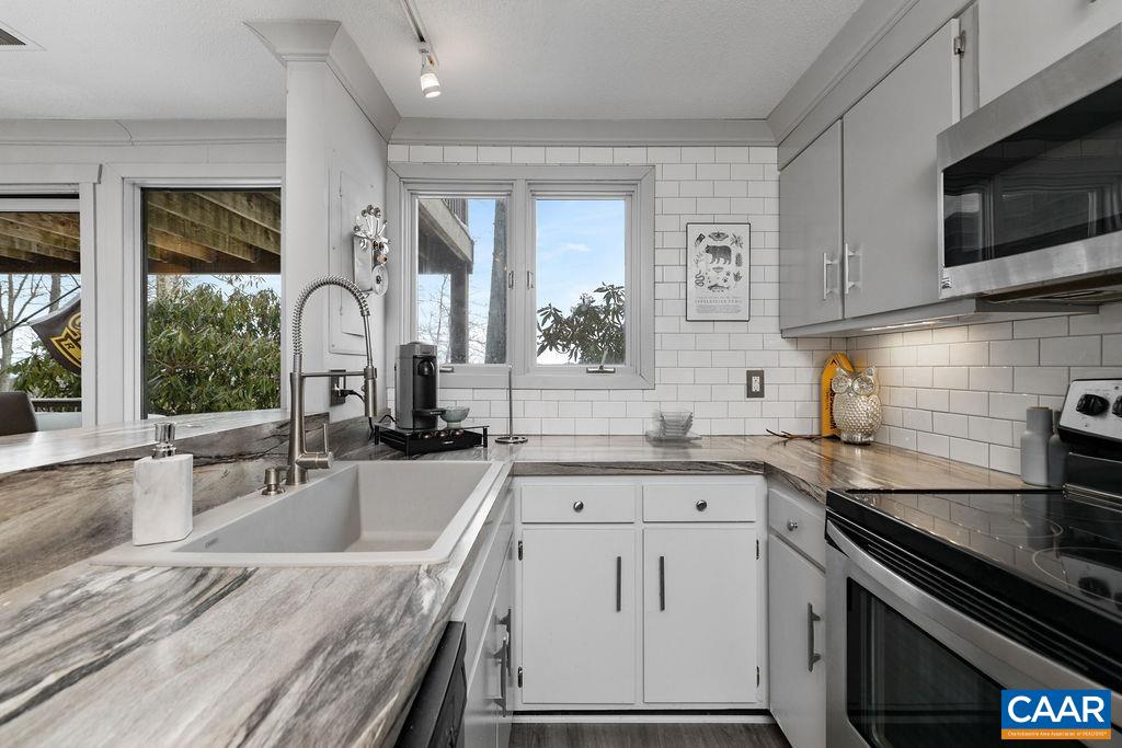 113 Eagles Court Roseland, VA 22967 - Photo 11 of 23 a kitchen with granite countertop a sink stainless steel appliances and cabinets