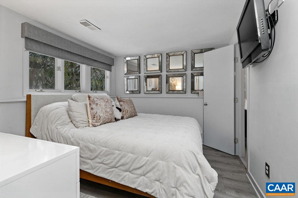 113 Eagles Court Roseland, VA 22967 - Photo 14 of 23 a bedroom with a bed a couch and large window