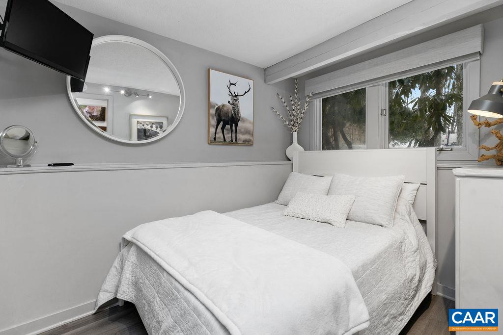 113 Eagles Court Roseland, VA 22967 - Photo 17 of 23 a bedroom with a large bed and a mirror