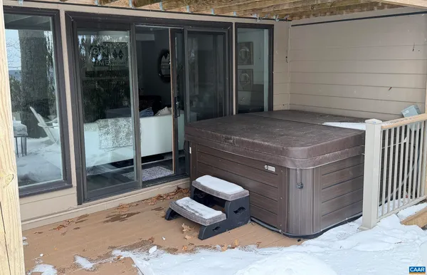 a view of a patio with a table chairs and a floor to ceiling window