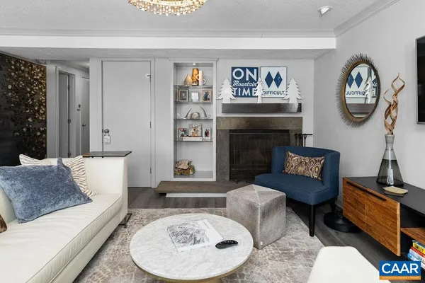 a living room with furniture and a fireplace
