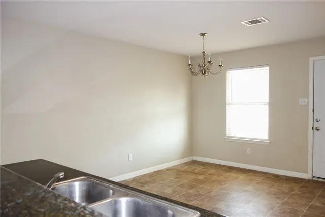 a view of a room with window and ceiling fan