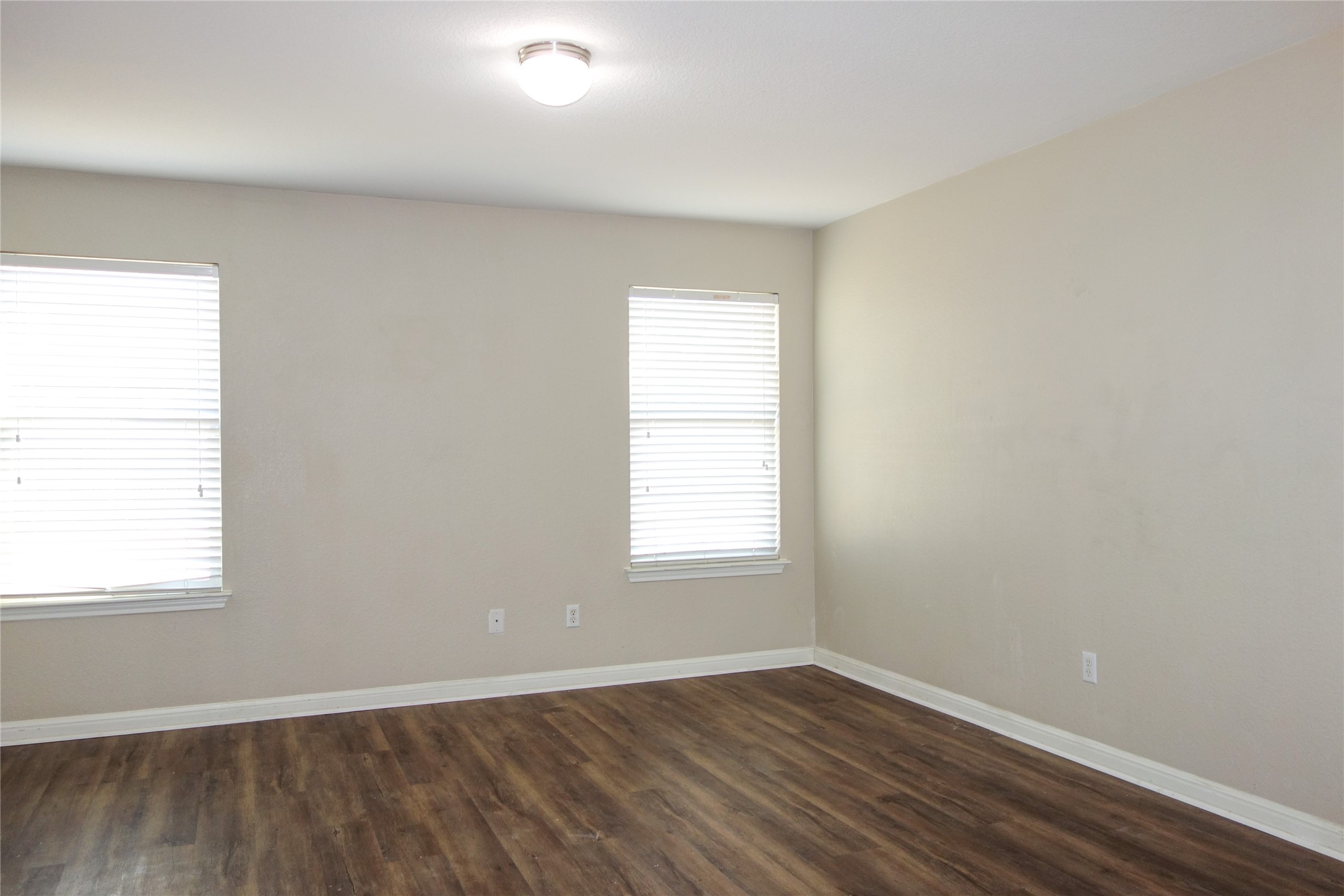 108 Lavaca Loop Hutto, TX 78634 - Photo 14 of 39 an empty room with wooden floor and windows
