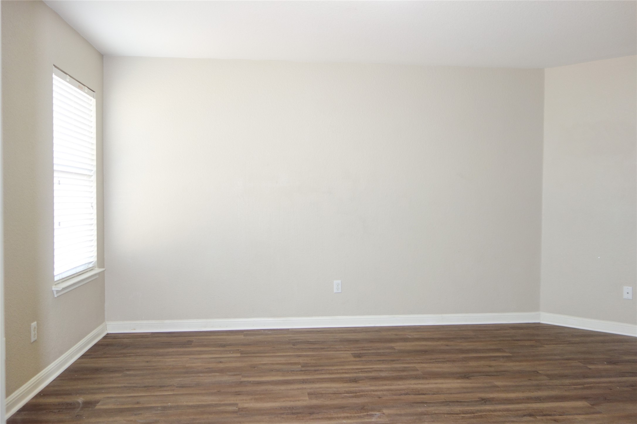108 Lavaca Loop Hutto, TX 78634 - Photo 15 of 39 a view of an empty room with wooden floor and a window