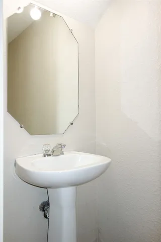 a bathroom with a sink and mirror