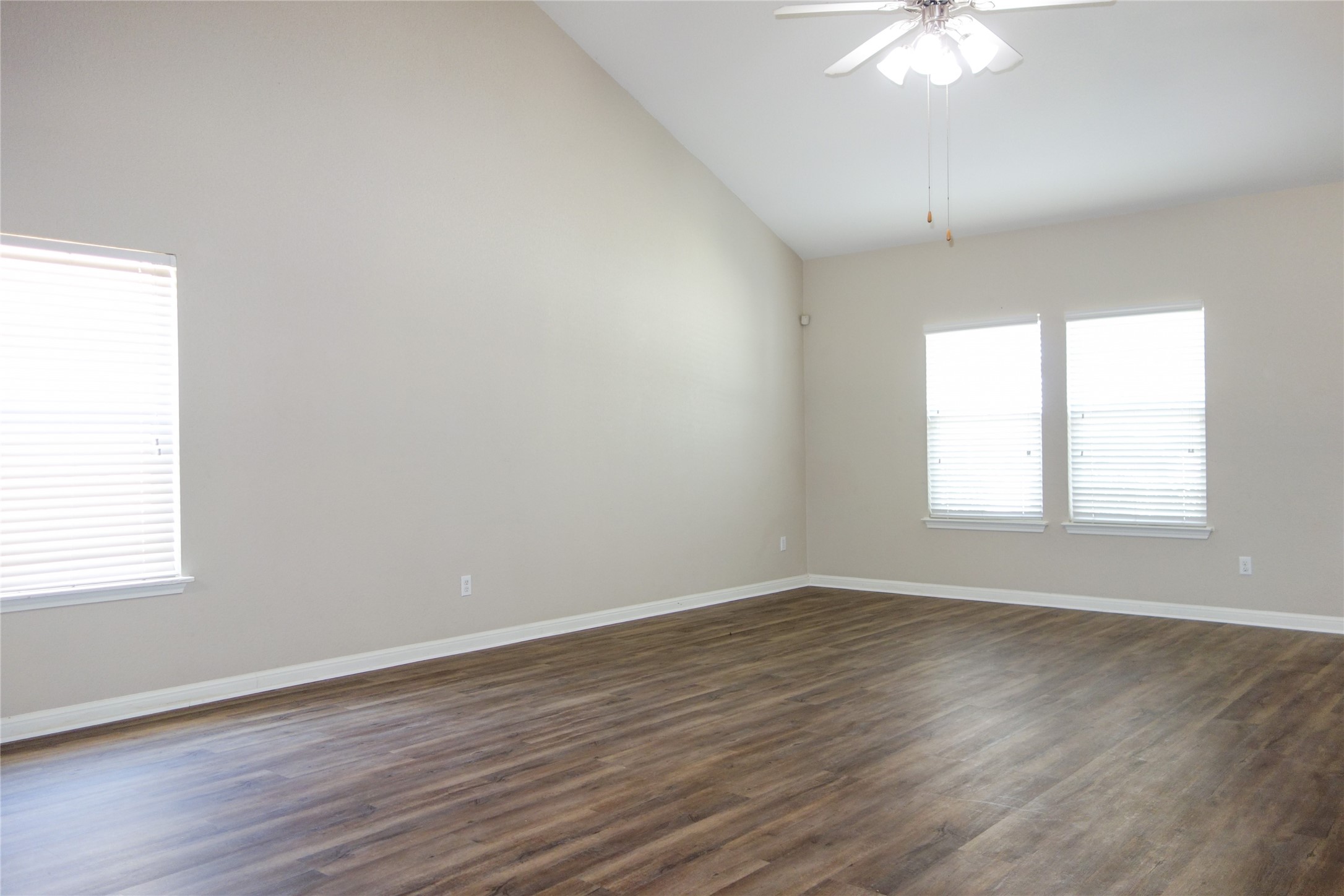 108 Lavaca Loop Hutto, TX 78634 - Photo 5 of 39 an empty room with wooden floor and windows