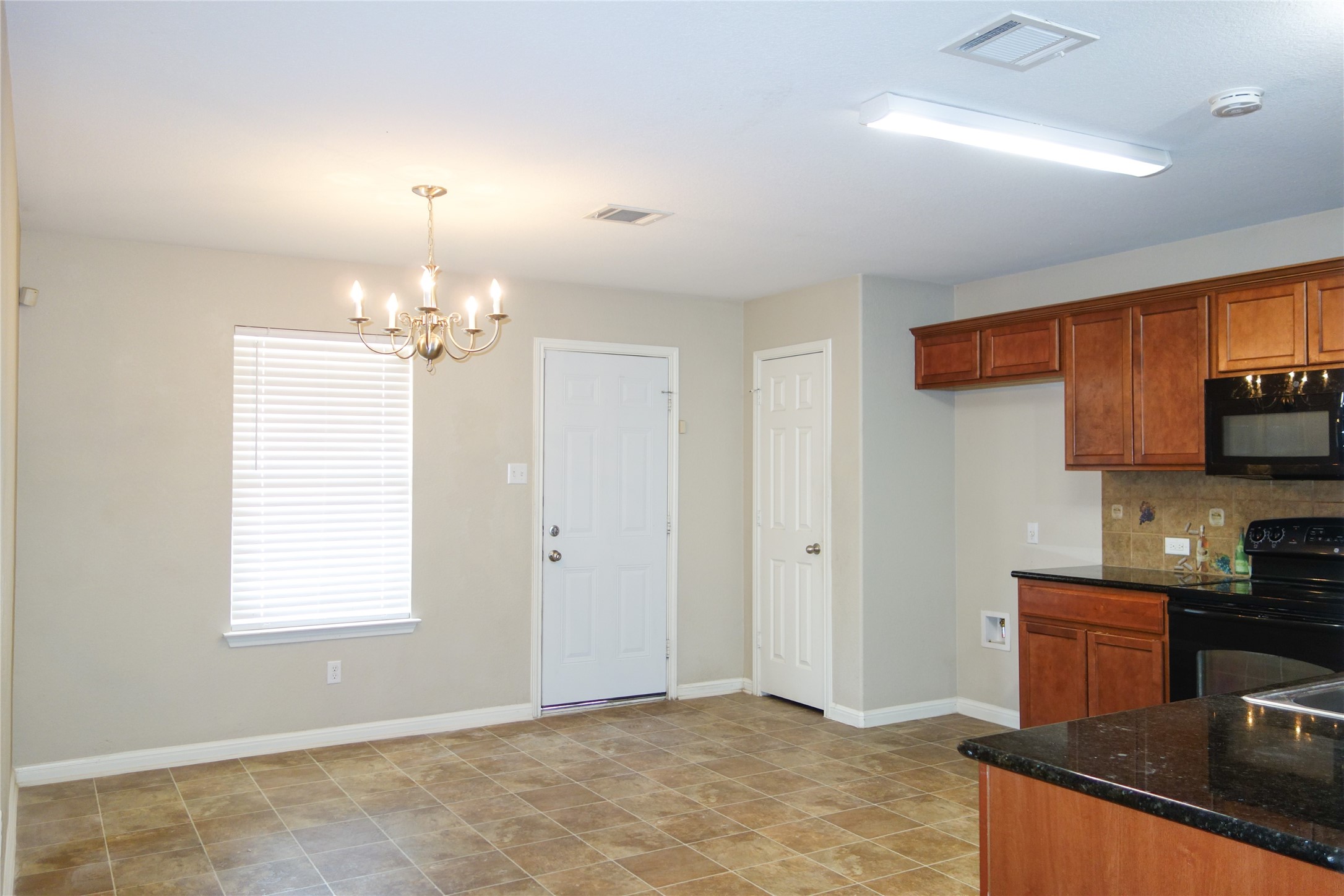 108 Lavaca Loop Hutto, TX 78634 - Photo 9 of 39 a view of a kitchen with kitchen island a sink wooden floor and window