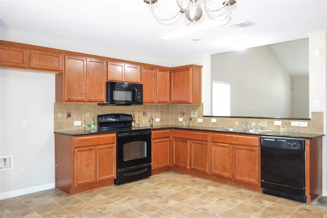 a kitchen with stainless steel appliances granite countertop a sink stove and microwave