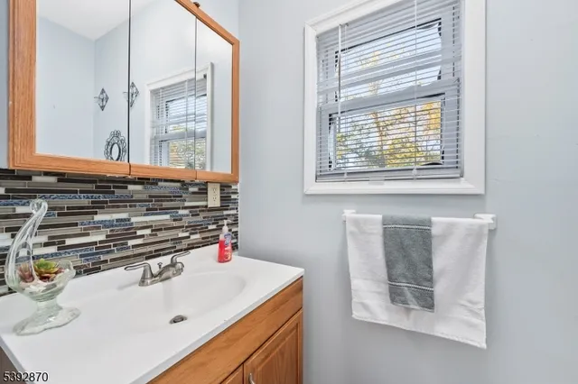 a bathroom with a sink and a window