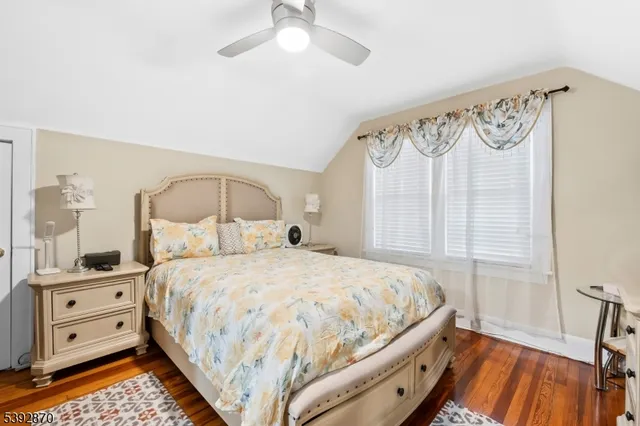a bedroom with a bed a window and a chandelier