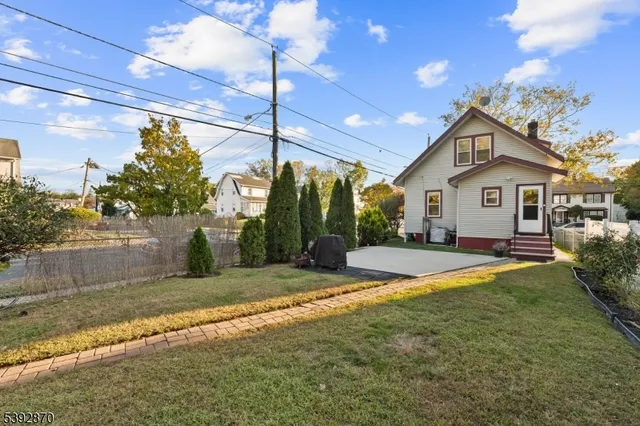 a view of a house with backyard and sitting area