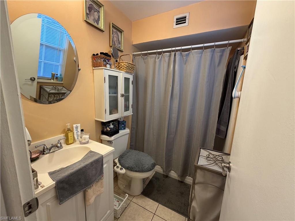 5352 16th Place Southwest, Unit G2 Naples, FL 34116 - Photo 12 of 17 a bathroom with a sink toilet and shower