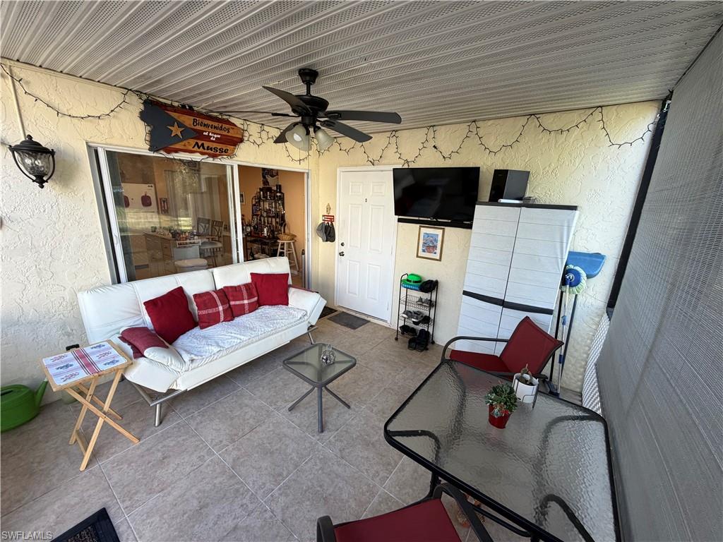 5352 16th Place Southwest, Unit G2 Naples, FL 34116 - Photo 16 of 17 a living room with furniture and a flat screen tv
