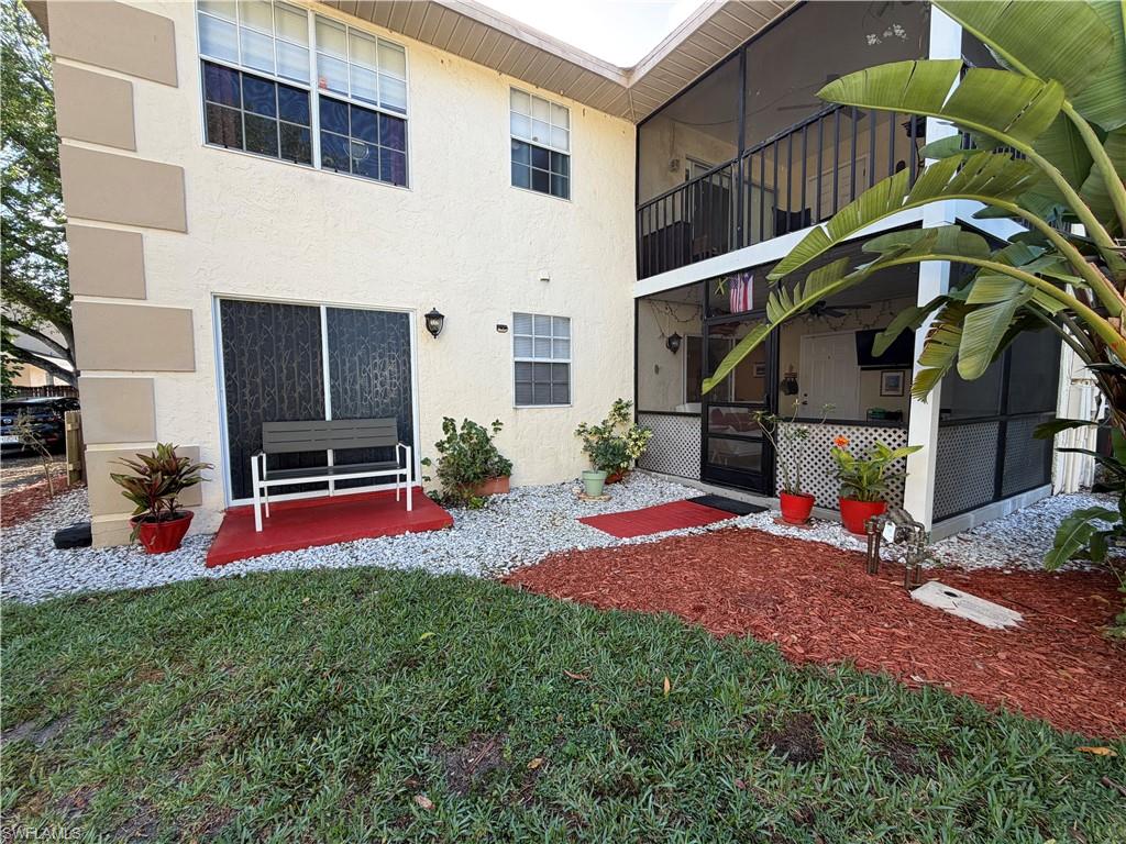 5352 16th Place Southwest, Unit G2 Naples, FL 34116 - Photo 4 of 17 a backyard of a house with table and chairs