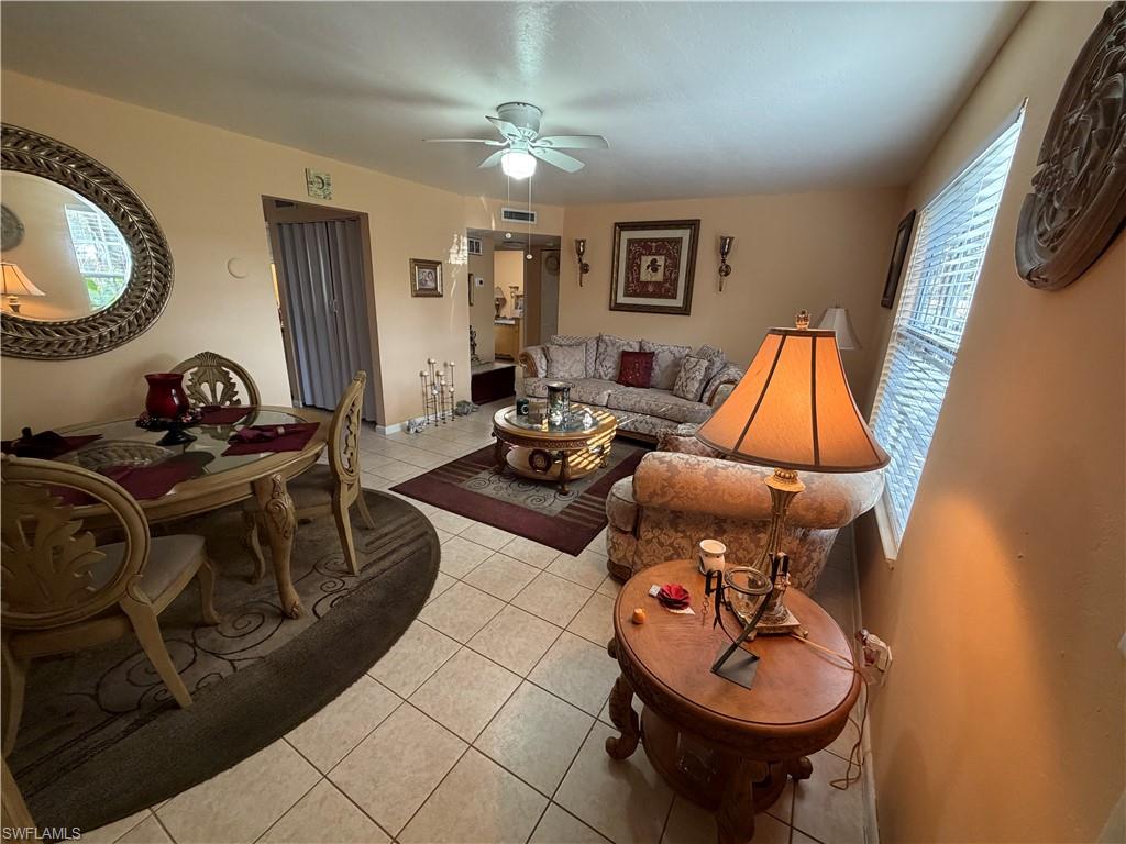 5352 16th Place Southwest, Unit G2 Naples, FL 34116 - Photo 5 of 17 a living room with furniture and a mirror
