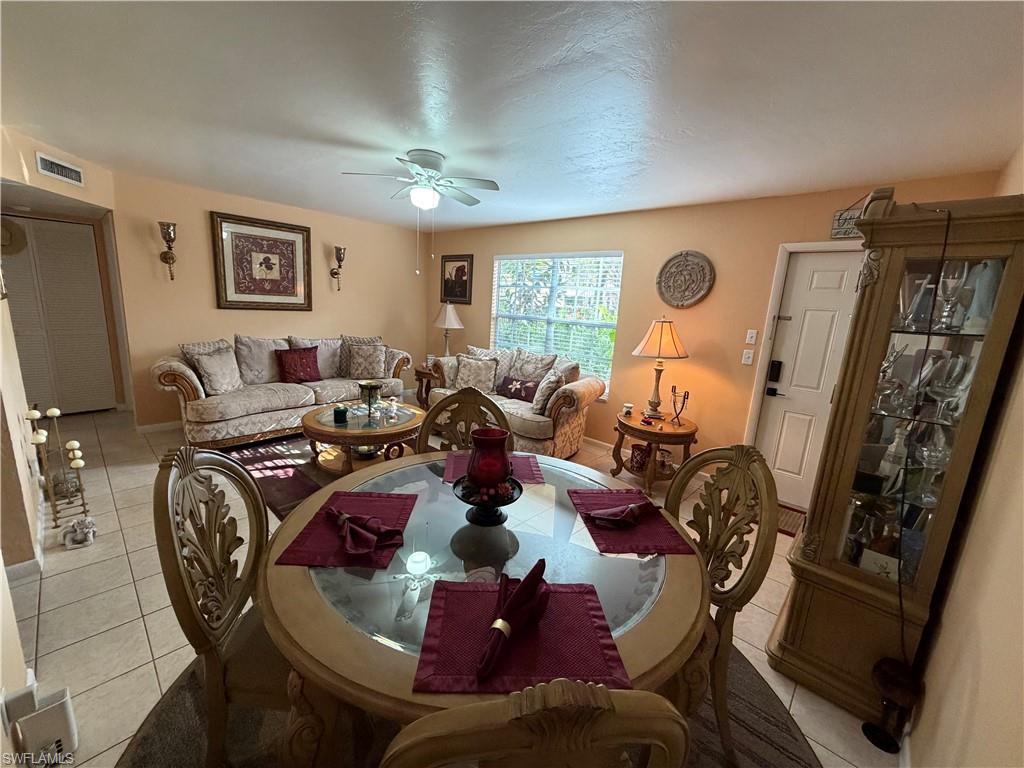 5352 16th Place Southwest, Unit G2 Naples, FL 34116 - Photo 6 of 17 a living room with furniture a flat screen tv and a window