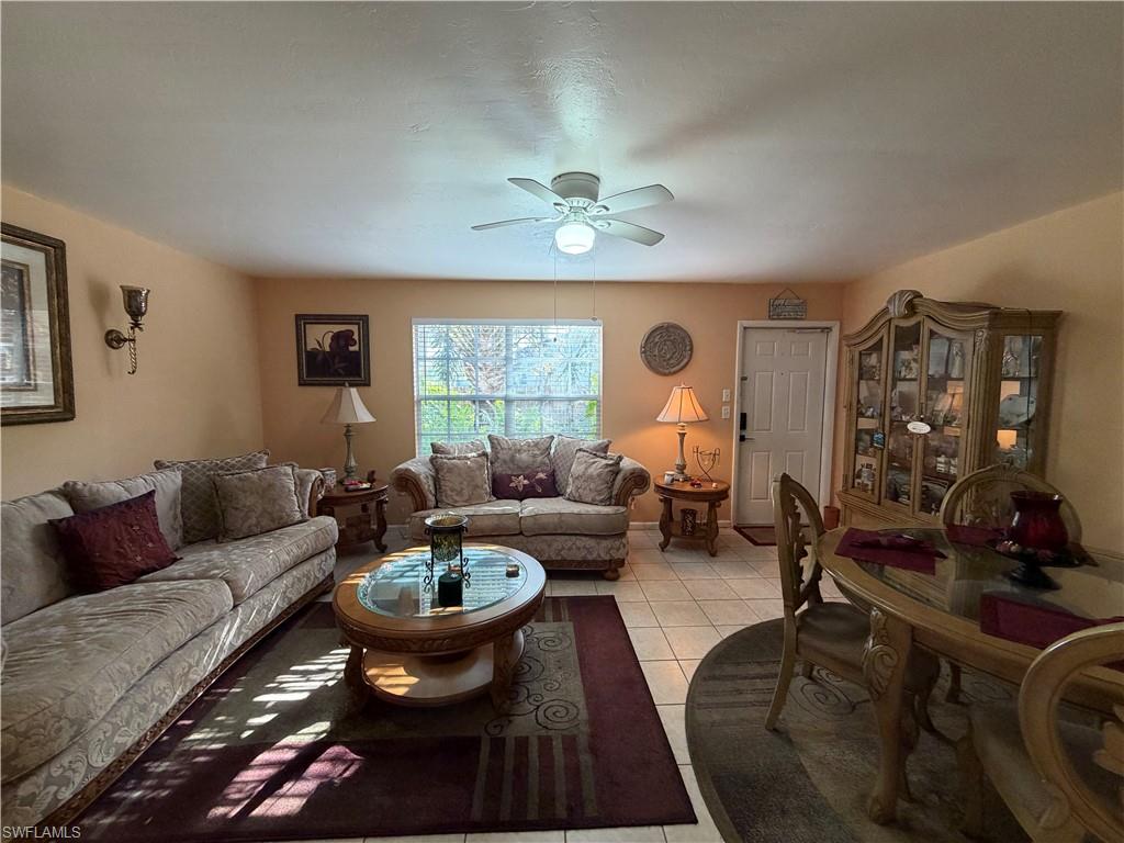 5352 16th Place Southwest, Unit G2 Naples, FL 34116 - Photo 7 of 17 a living room with furniture and a large window
