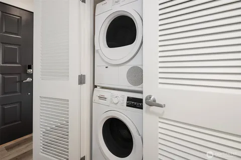 a close view of a utility room with dryer and washer