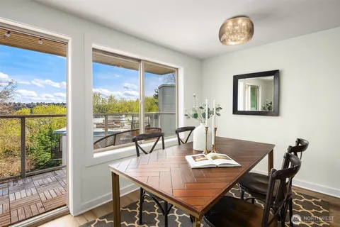 a view of a dining room with furniture large windows and wooden floor
