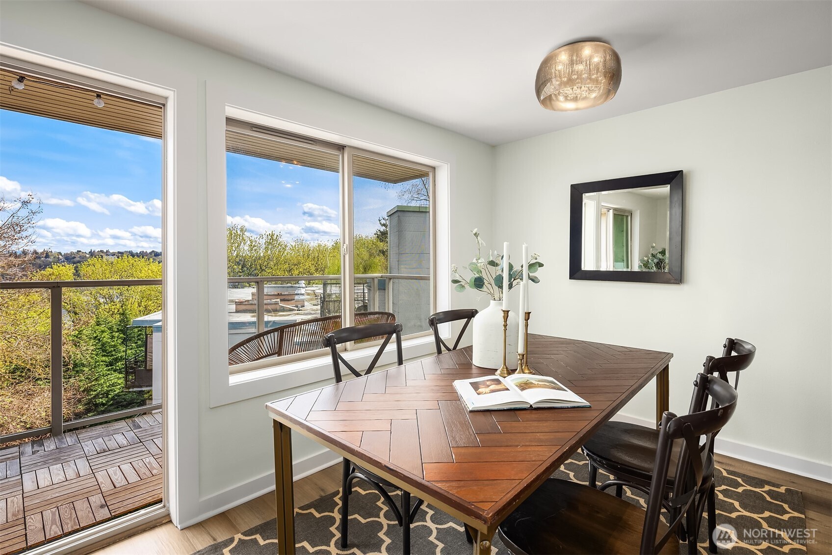 1730 Taylor Avenue North, Unit 409 Seattle, WA 98109 - Photo 15 of 22 a view of a dining room with furniture large windows and wooden floor